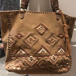 Brown leather, stitched bag with a tassel